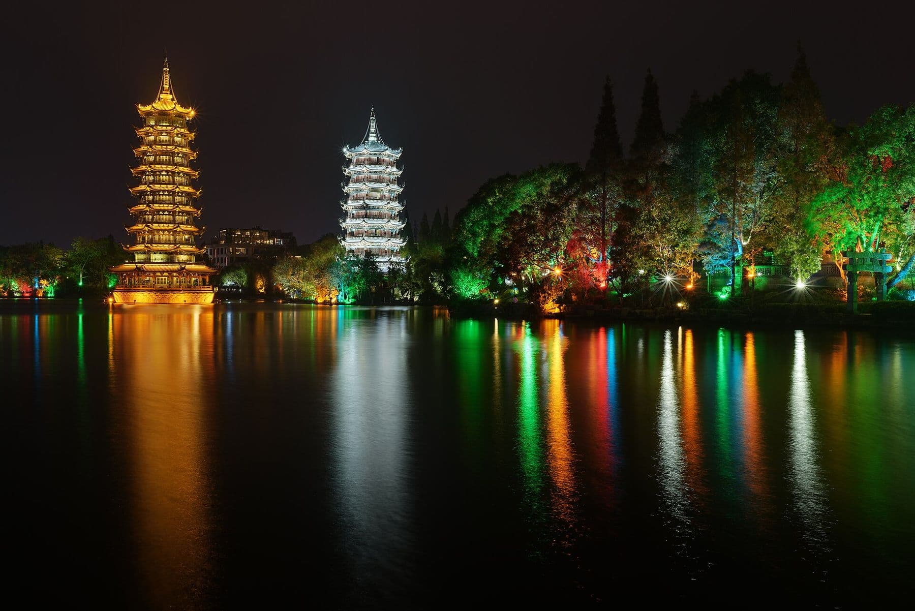 The Sun and Moon Pagodas reflected in Shan Lake at night, Guilin